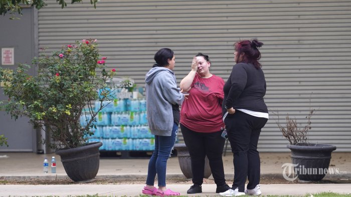 Teman dan keluarga berkumpul dalam duka di luar Willie de Leon Civic Center di mana konseling duka akan ditawarkan di Uvalde, Texas, pada 24 Mei 2022. - Seorang pria bersenjata remaja membunuh 18 anak kecil dalam penembakan di sebuah sekolah dasar di Texas pada hari Selasa, dalam penembakan sekolah AS paling mematikan dalam beberapa tahun. Serangan di Uvalde, Texas -- sebuah komunitas kecil sekitar satu jam dari perbatasan Meksiko -- adalah yang terbaru dari serangkaian penembakan mematikan di Amerika, di mana kengerian pada siklus kekerasan senjata telah gagal memacu tindakan untuk mengakhirinya. (Photo by allison dinner / AFP)